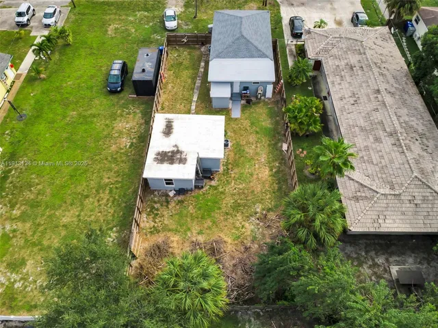 an aerial view of a house with a yard