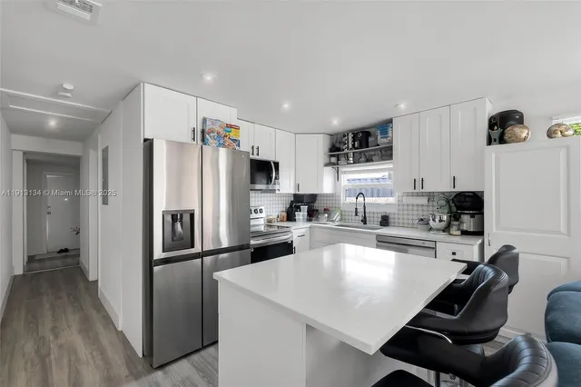 a kitchen with refrigerator cabinets and a counter top space