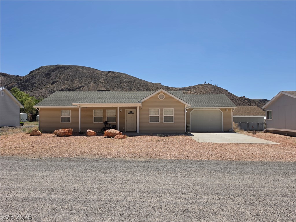 5 Love Lane Caliente, NV 89008 - Photo 1 of 2 A desert-modern home with an attached garage offers mountain views and a xeriscaped front.