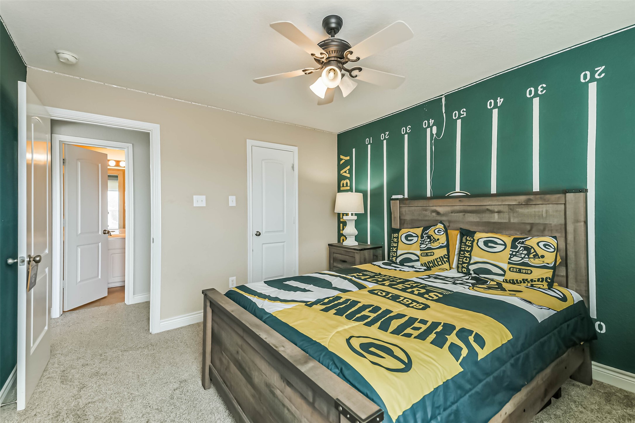 19022 Greenleaf Ridge Court Cypress, TX 77429 - Photo 38 of 47 a bedroom with a bed and a chandelier