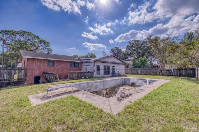 a front view of a house with a yard table and chairs