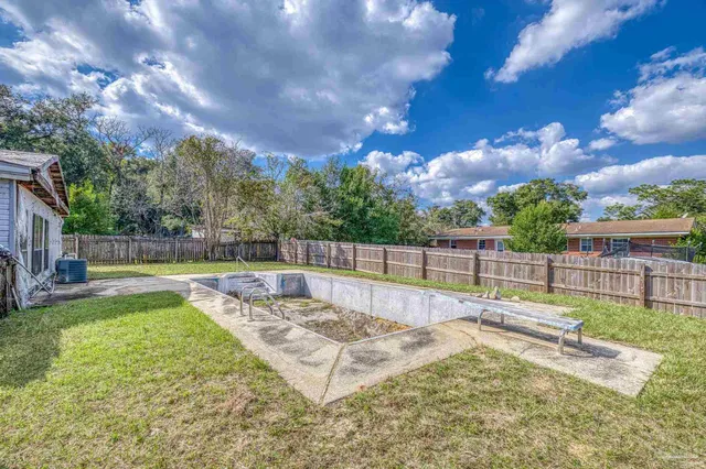 a view of a backyard with swimming pool