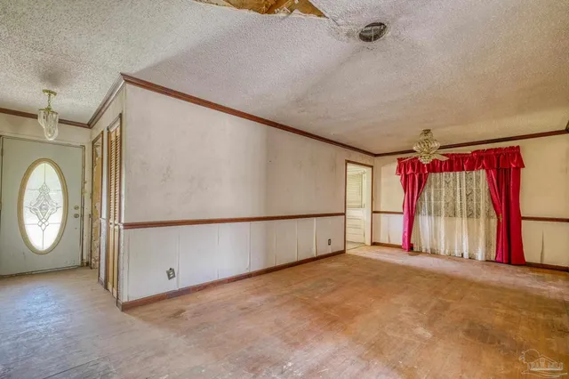 a view of a livingroom with wooden floor and window