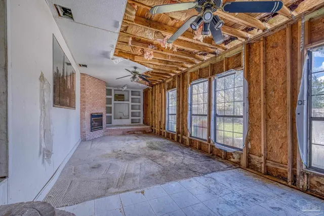 a room with a fireplace and a rug