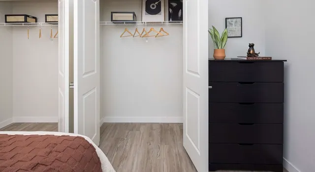 a bedroom with a bed and a dresser