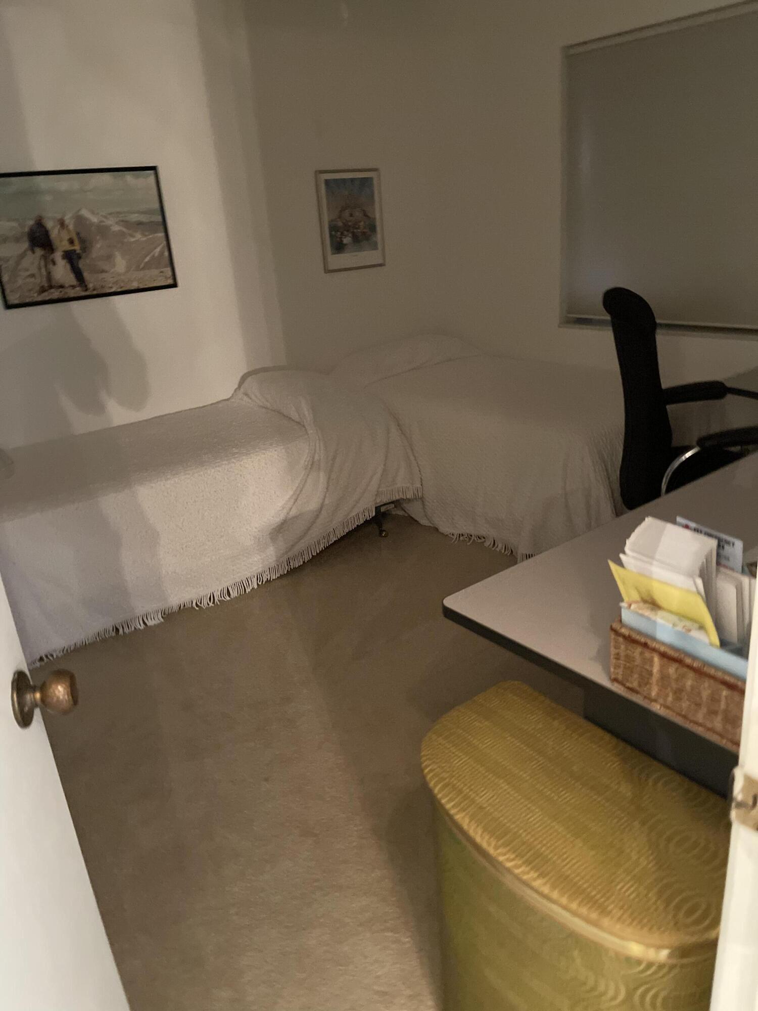 4291 Northwest 9th Avenue, Unit 104 Deerfield Beach, FL 33064 - Photo 2 of 11 a bed sitting in a bedroom next to a larger window