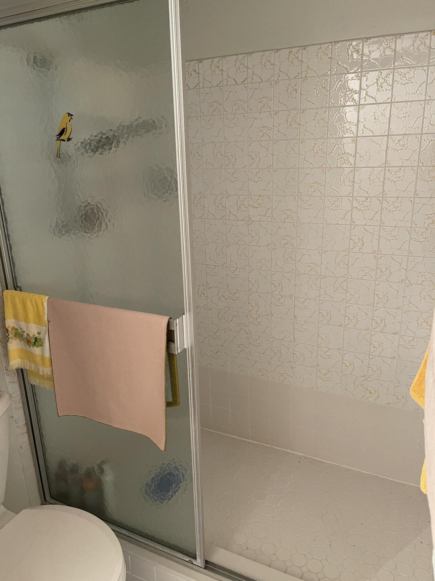 4291 Northwest 9th Avenue, Unit 104 Deerfield Beach, FL 33064 - Photo 3 of 11 a bathroom with a granite countertop sink and a toilet