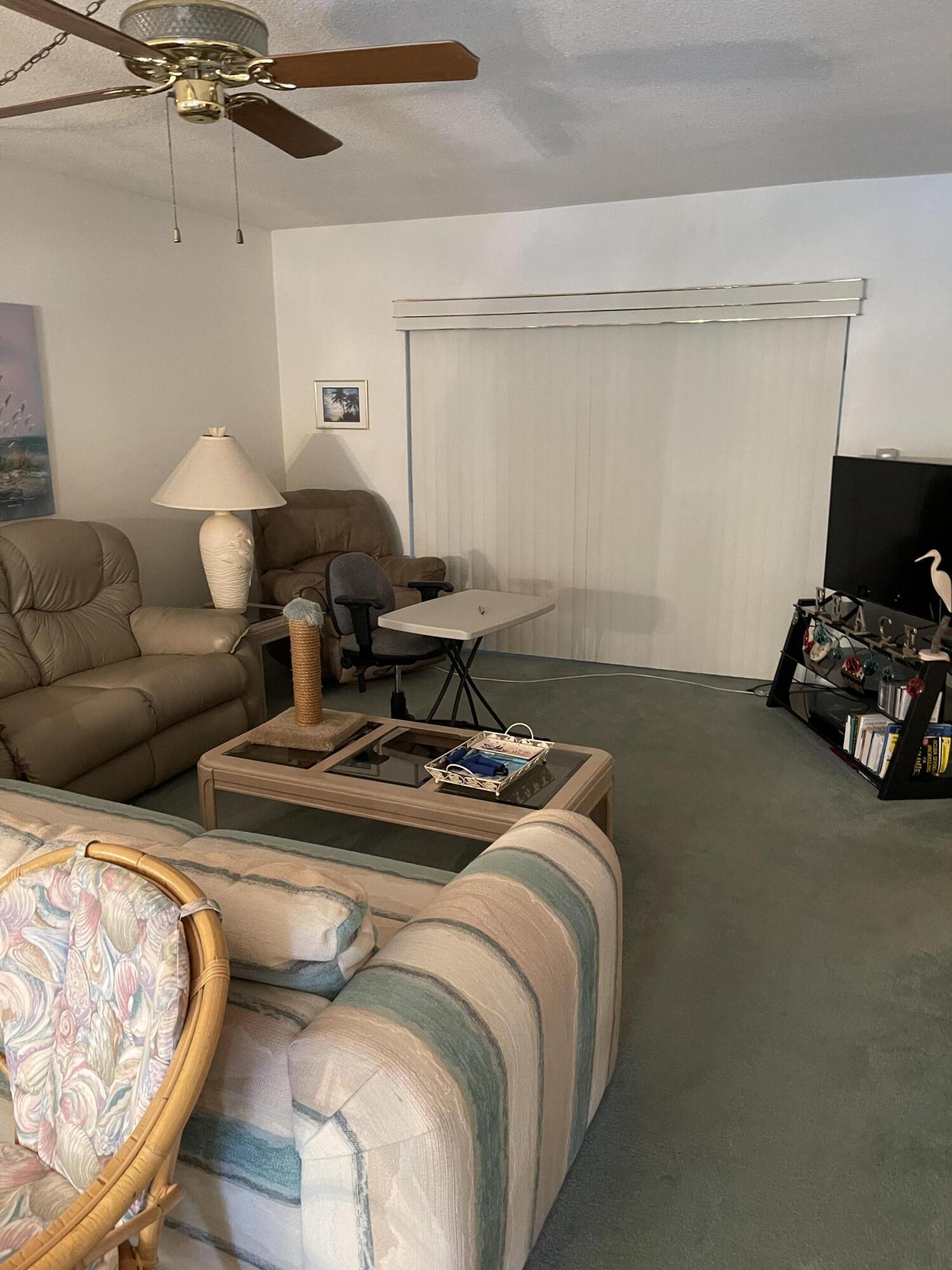 4291 Northwest 9th Avenue, Unit 104 Deerfield Beach, FL 33064 - Photo 4 of 11 a bed room with furniture and a window