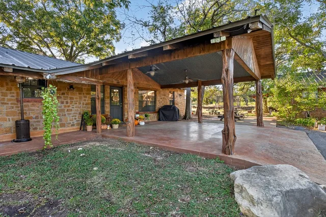 a view of a patio with table and chairs under an umbrella