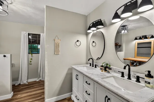 a bathroom with a double vanity sink and a mirror