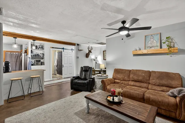 a living room with furniture a rug and a chandelier