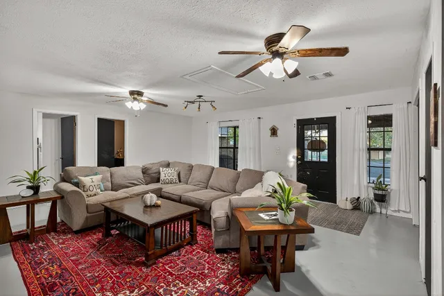 a living room with furniture and wooden floor