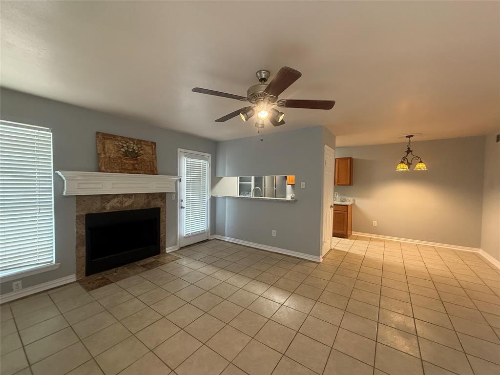 5981 Arapaho Road, Unit 1503 Dallas, TX 75248 - Photo 3 of 14 a view of an empty room and fire place