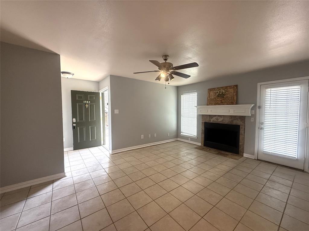 5981 Arapaho Road, Unit 1503 Dallas, TX 75248 - Photo 4 of 14 a view of an empty room with a fireplace and a window