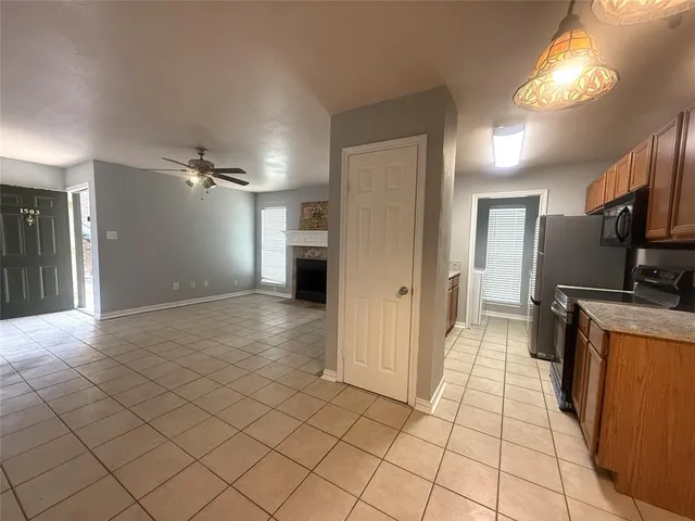 a view of a kitchen with a sink and a refrigerator
