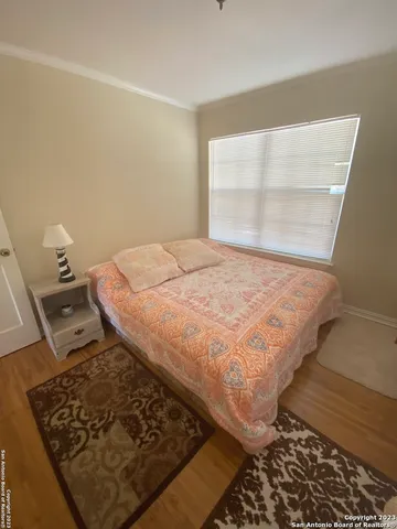 a bed sitting in a bedroom next to a window