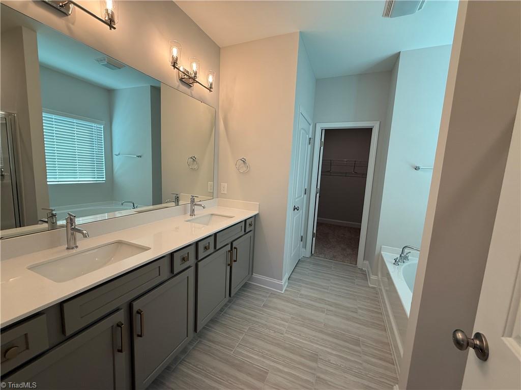 3301 Alyssa Way High Point, NC 27265 - Photo 31 of 43 Primary bath with tile floors and garden tub and shower
