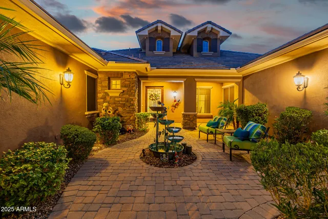 a bathroom with a granite countertop toilet sink and mirror