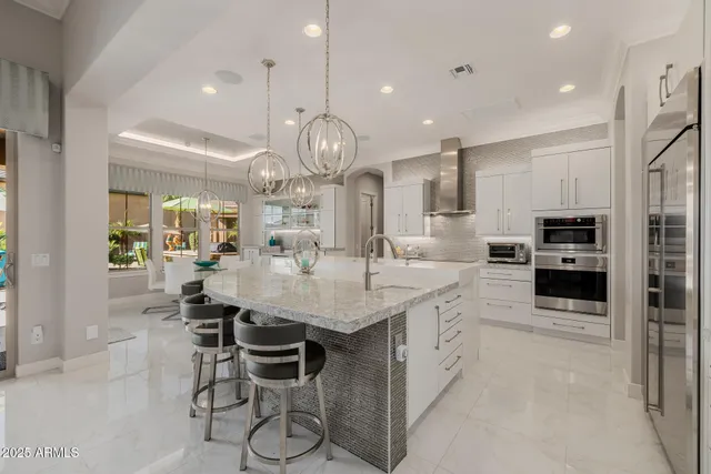 a living room with furniture a floor to ceiling window and a flat screen tv