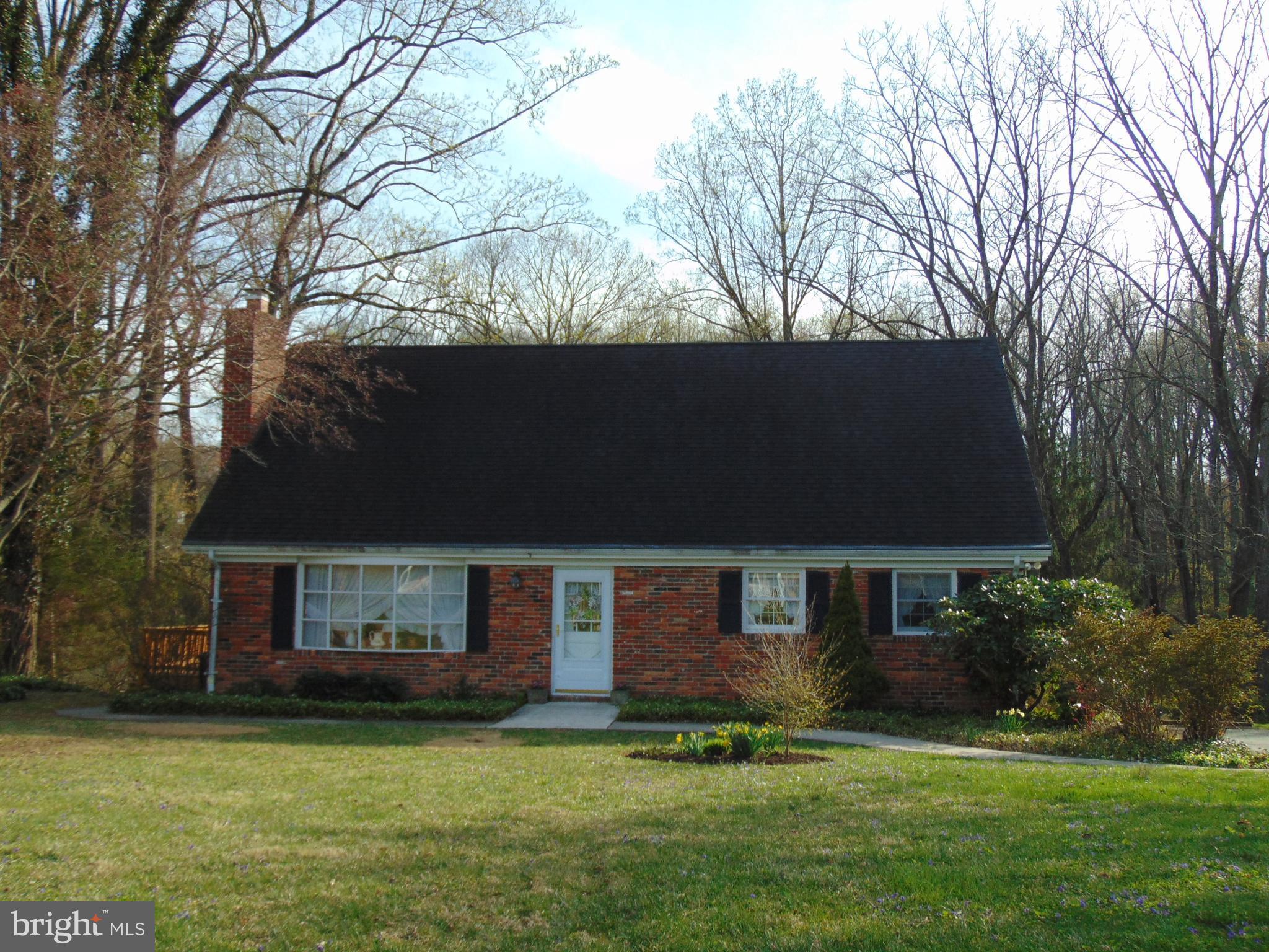 1102 Mill Creek Road Fallston, MD 21047 - Photo 1 of 28 a front view of a house with a garden and trees