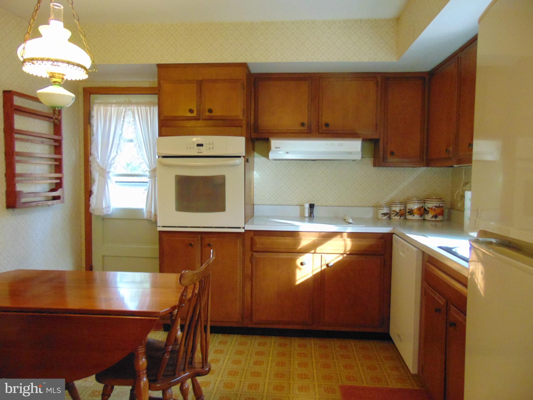 1102 Mill Creek Road Fallston, MD 21047 - Photo 10 of 28 a kitchen with stainless steel appliances granite countertop wooden cabinets a refrigerator a sink and a stove
