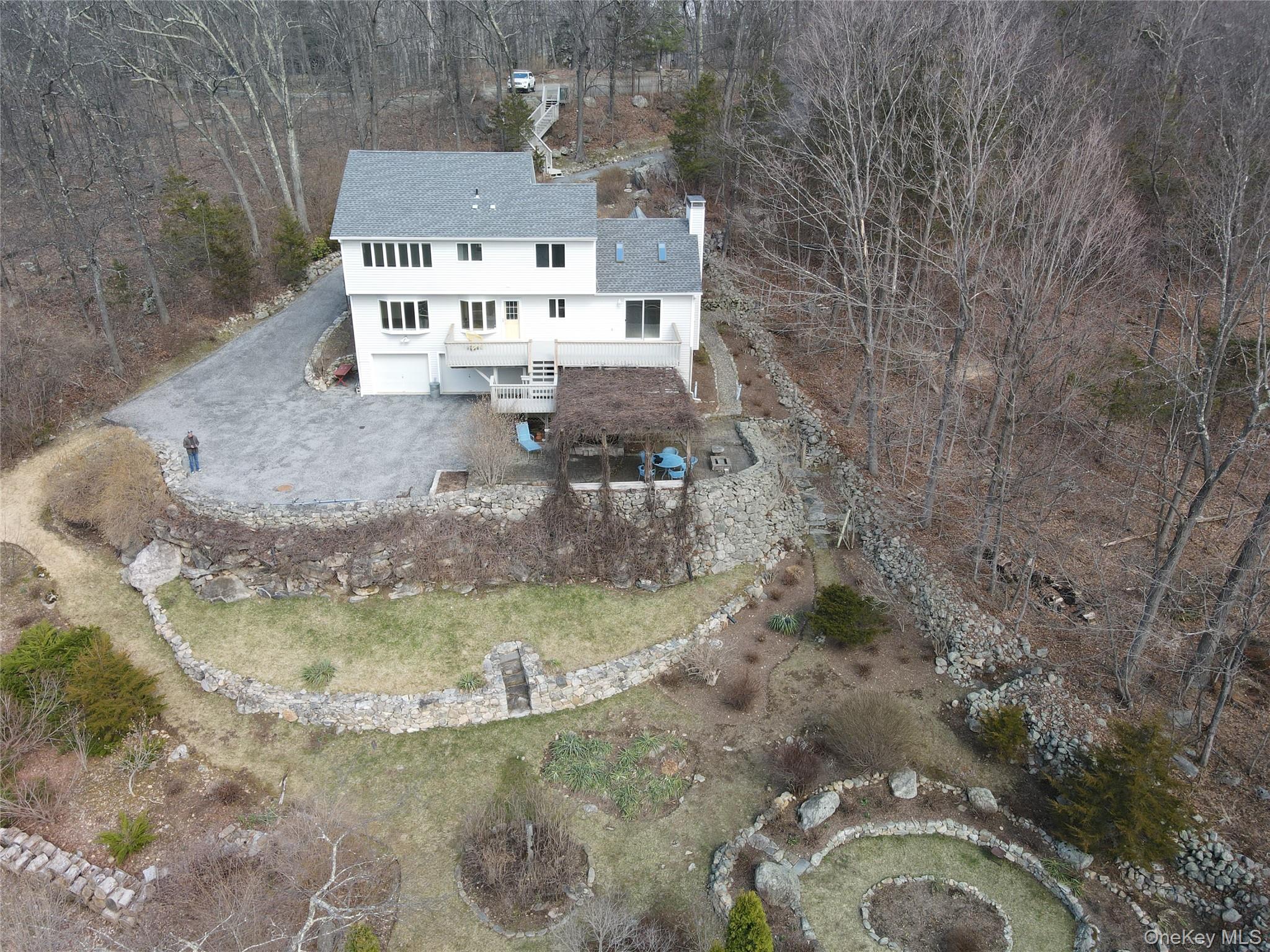 50 Downey Lane Cold Spring, NY 10516 - Photo 4 of 24 Rear view with sun filled gardens/yard/rear deck.patio w/fish pond