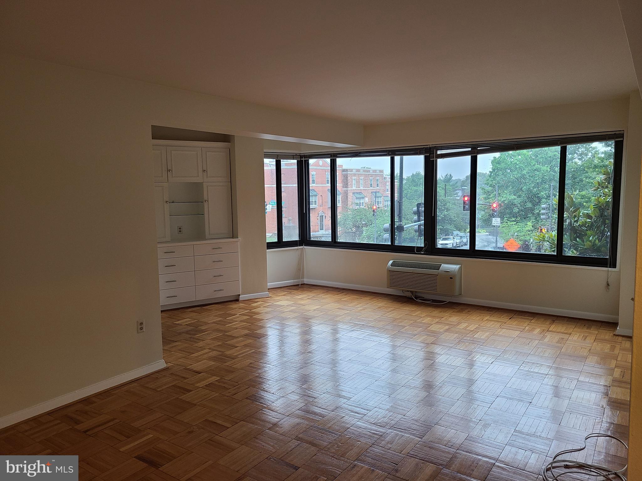 3601 Wisconsin Avenue Northwest, Unit 204 Washington, DC 20016 - Photo 1 of 11 wooden floor in an empty room with a window