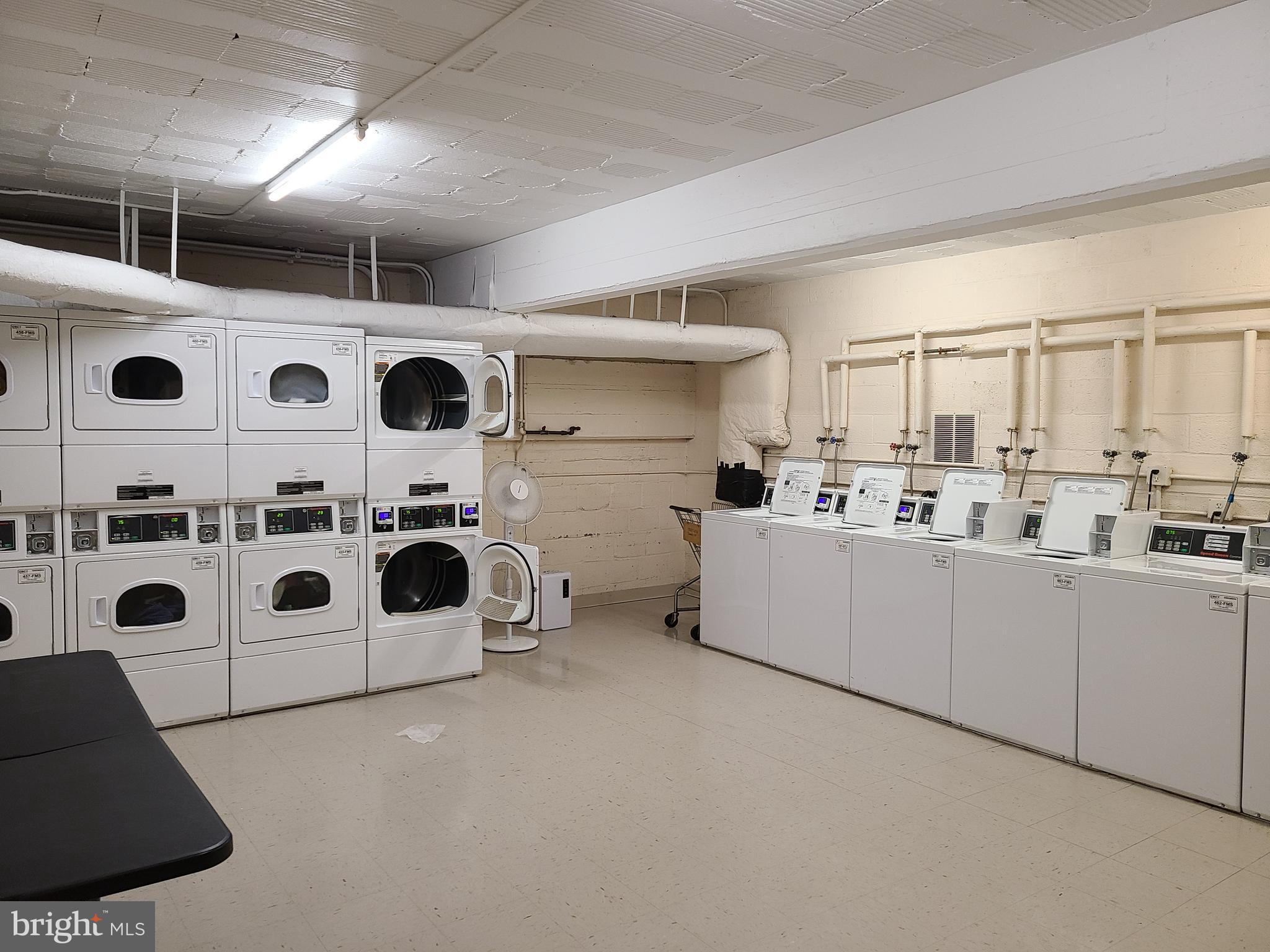 3601 Wisconsin Avenue Northwest, Unit 204 Washington, DC 20016 - Photo 11 of 11 a utility room with stainless steel appliances large white cabinets and a window