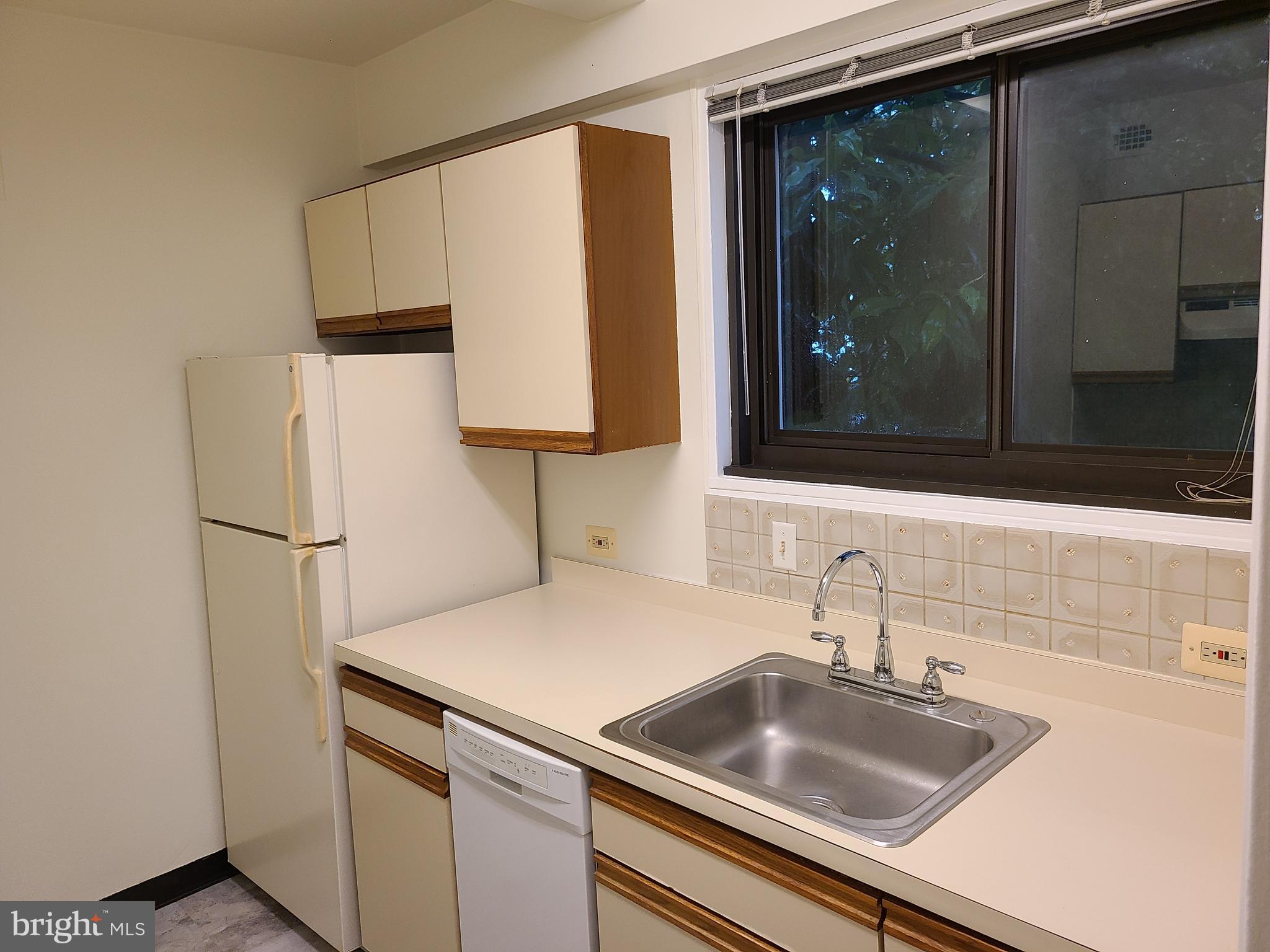 3601 Wisconsin Avenue Northwest, Unit 204 Washington, DC 20016 - Photo 4 of 11 a kitchen with a sink and a refrigerator