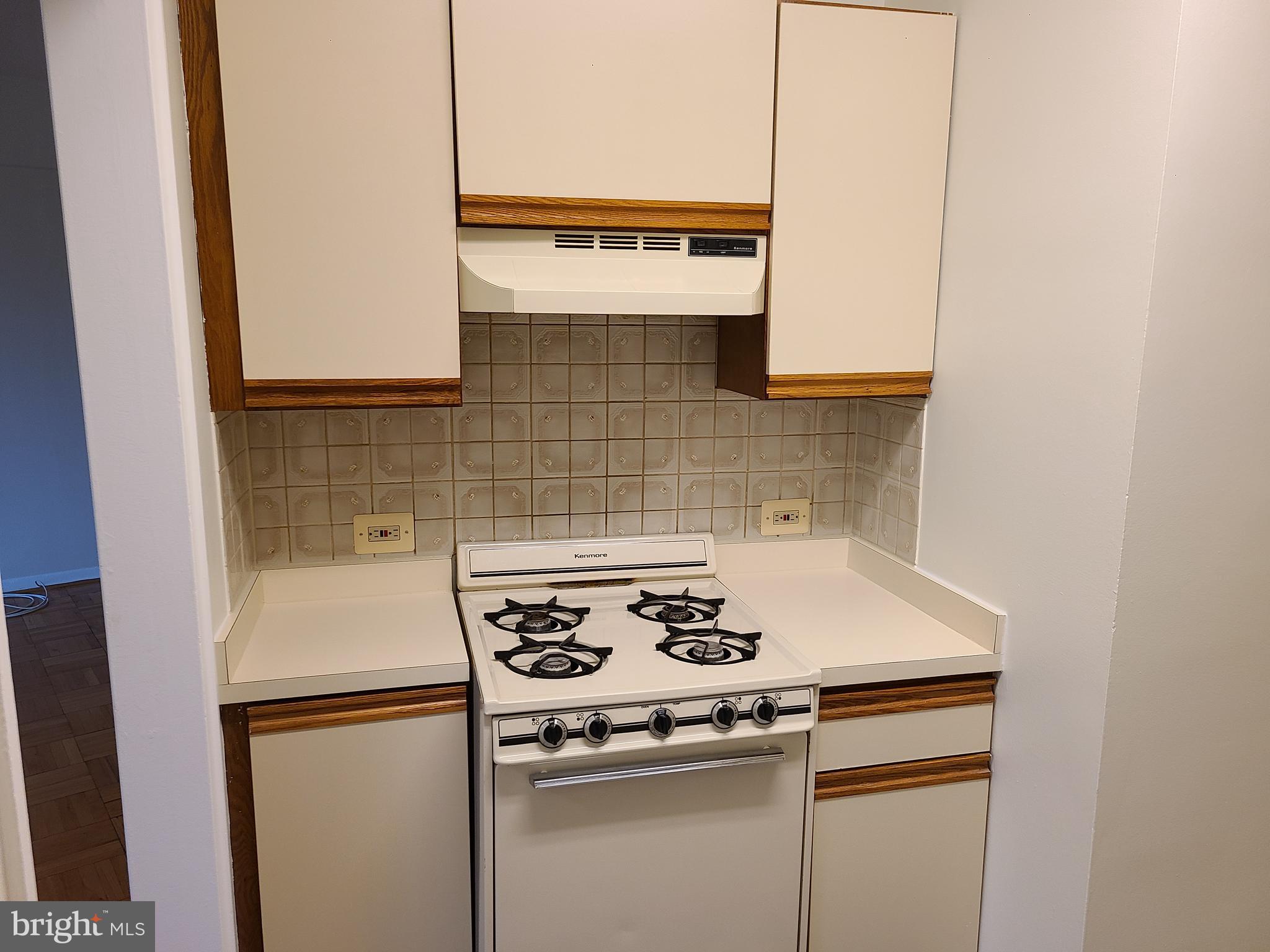 3601 Wisconsin Avenue Northwest, Unit 204 Washington, DC 20016 - Photo 5 of 11 a white stove top oven sitting inside of a kitchen