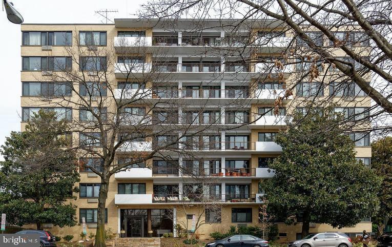 3601 Wisconsin Avenue Northwest, Unit 204 Washington, DC 20016 - Photo 9 of 11 a front view of a building with glass windows and a street