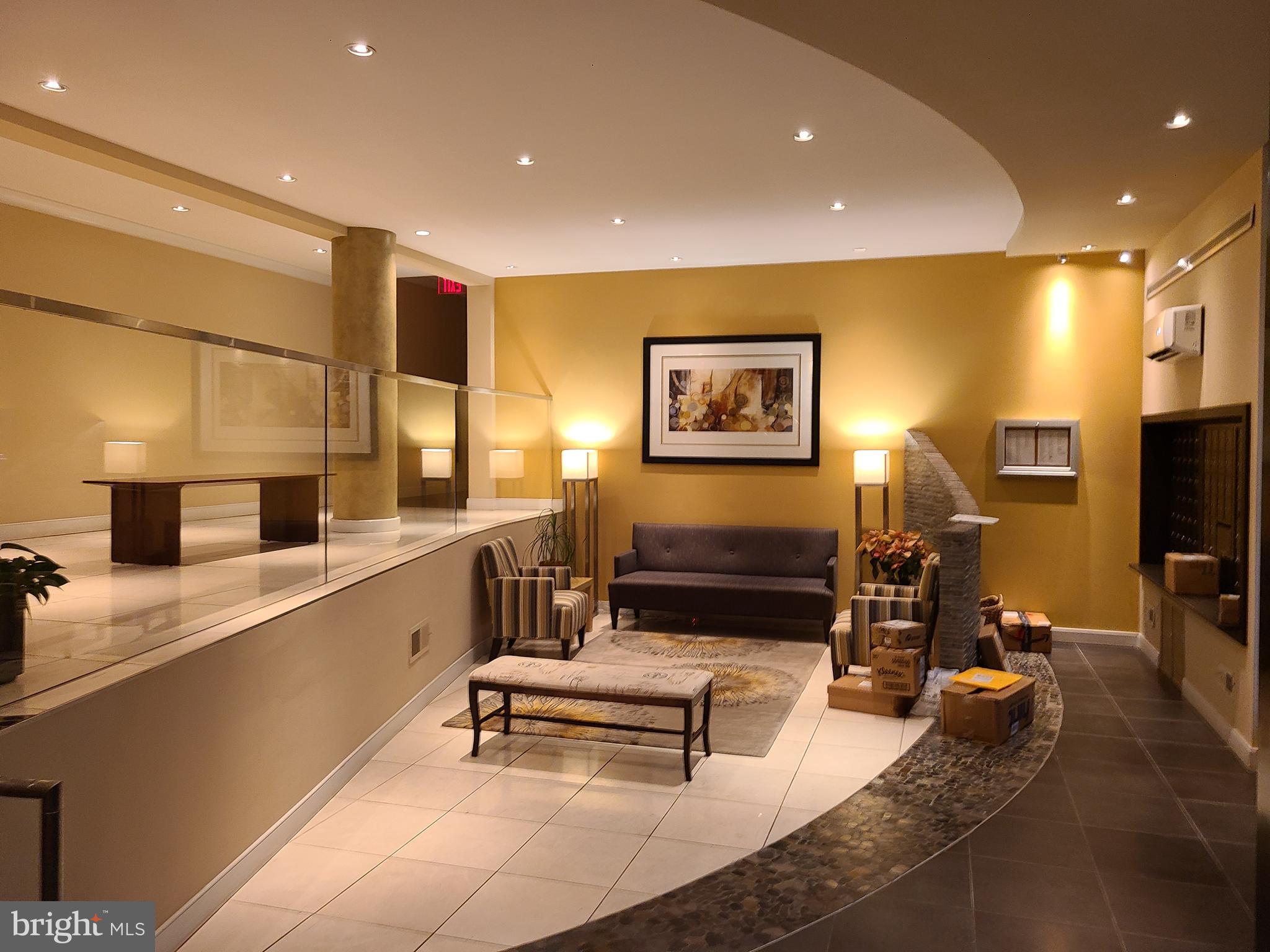 3601 Wisconsin Avenue Northwest, Unit 204 Washington, DC 20016 - Photo 10 of 11 a living room with furniture and a flat screen tv