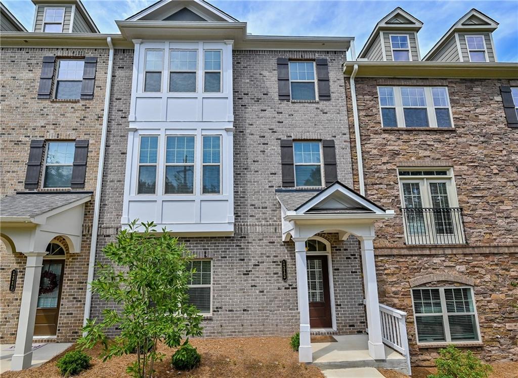 1313 Harris Way South Brookhaven, GA 30319 - Photo 1 of 1 front view of a brick house with a windows and a pathway