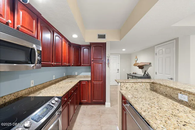a kitchen with stainless steel appliances granite countertop a stove and a sink