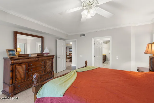 a bedroom with a bed and a mirror on dresser