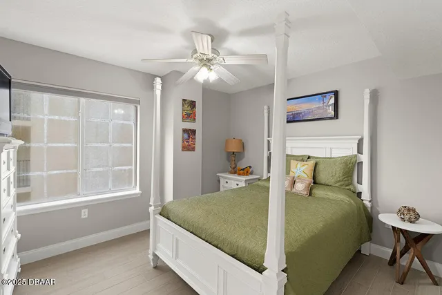 a bed sitting in a bedroom next to a window