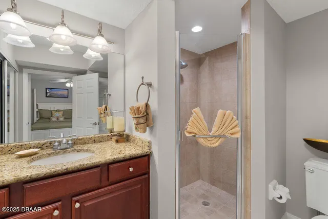 a bathroom with a granite countertop sink a mirror and a shower