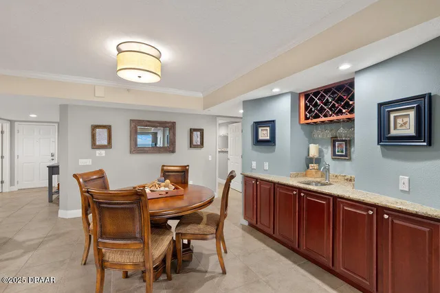 a dining room with a wooden table and chairs