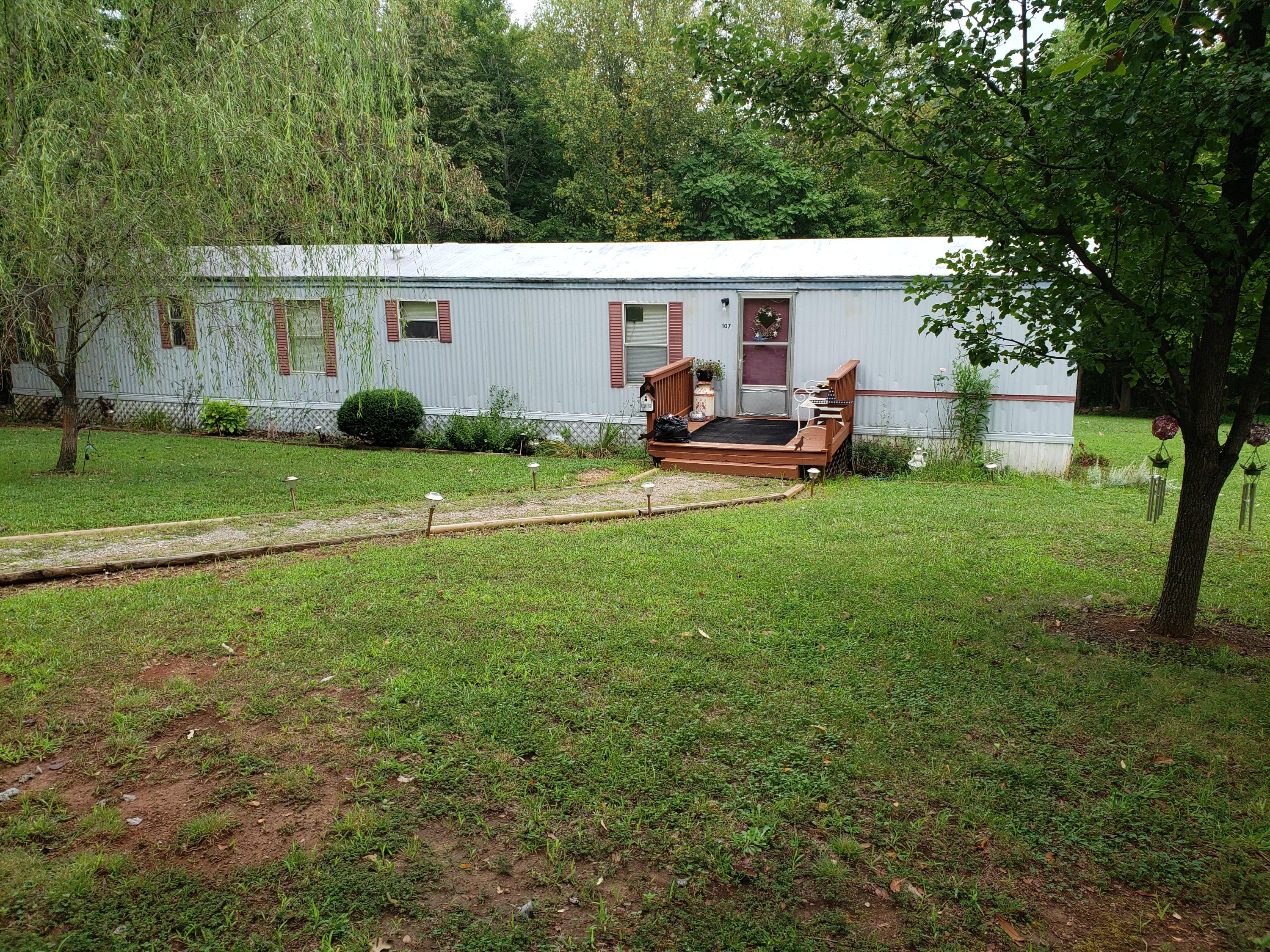 107 Board Mountain Road Goodview, VA 24095 - Photo 1 of 14 a view of an house with backyard space and sitting area