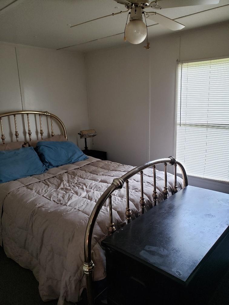107 Board Mountain Road Goodview, VA 24095 - Photo 7 of 14 a bed sitting in a bedroom next to a window