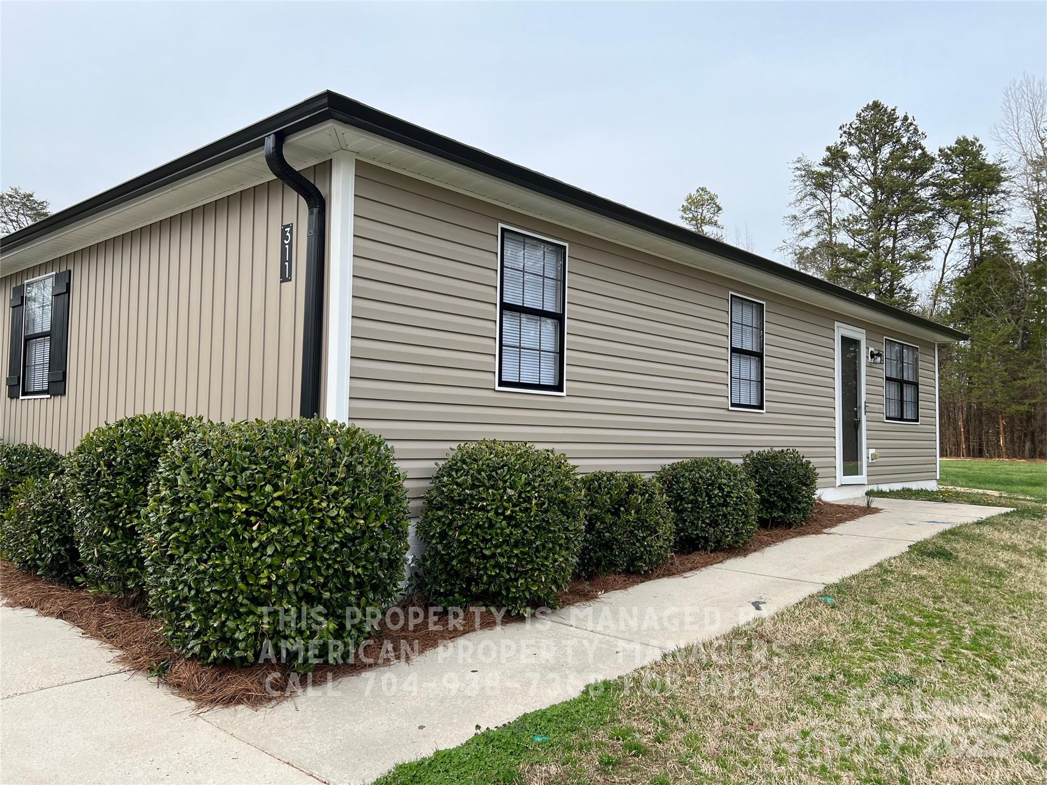 311 Rustic Road Mooresville, NC 28115 - Photo 2 of 10 a front view of a house with a yard