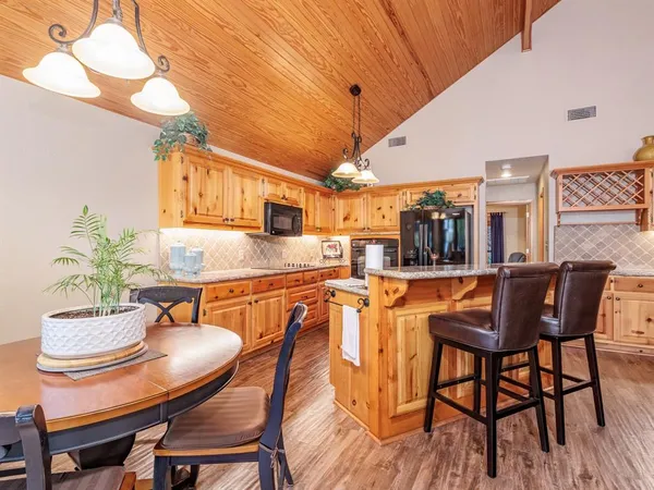 a dining room with furniture and wooden floor