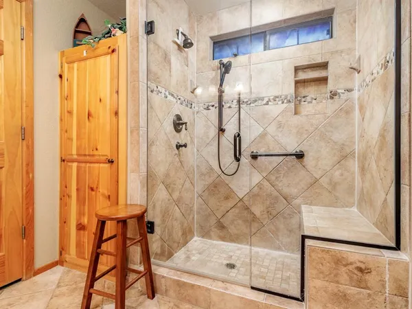 a bathroom with a glass shower door