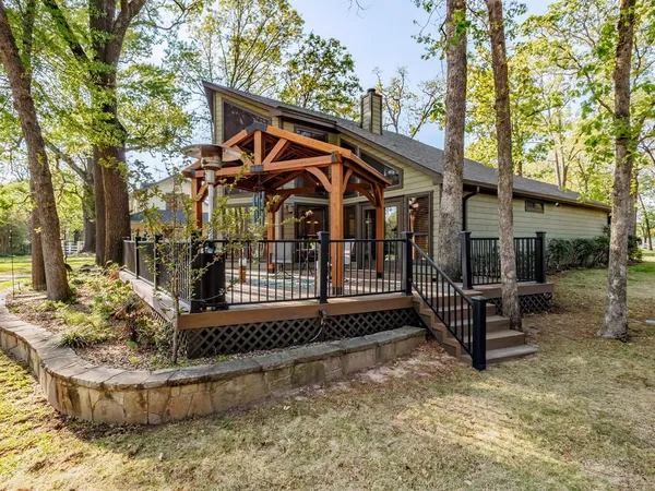 a view of a house with a small yard and wooden fence