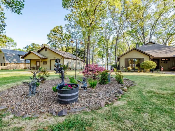 a front view of a house with a yard and potted plants