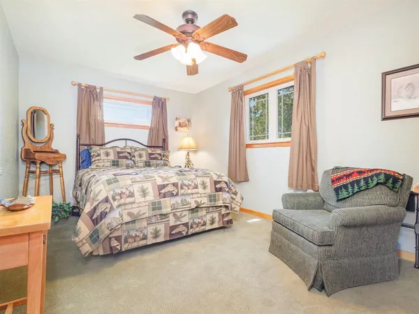 a bedroom with a bed couch and window