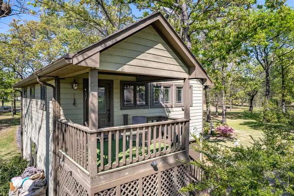 a view of a house with a small yard and wooden fence