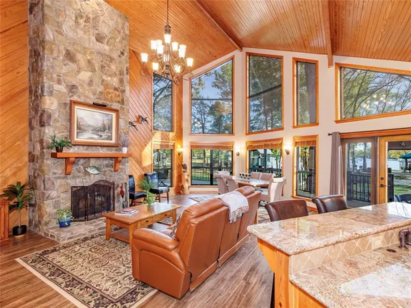 a living room with fireplace furniture and a large window