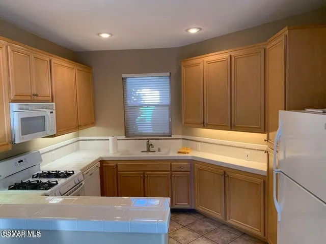 a view of an entryway with wooden floor and a door