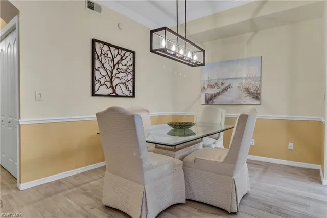 a view of a dining room with furniture and chandelier